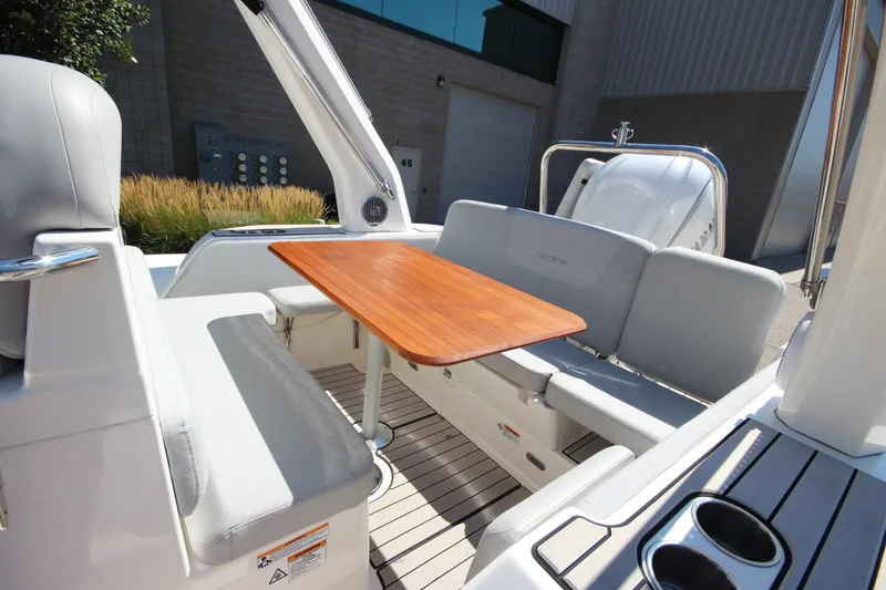 Slide: The Image of 2023 Zodiac Medline 7.5 boat interior with seating and wooden table. - 10