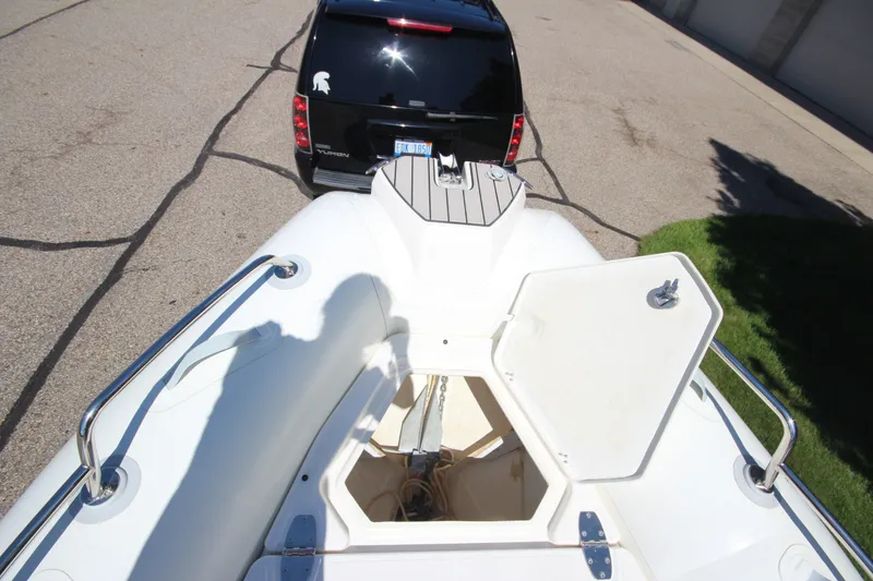 Slide: The Image of 2023 Zodiac Medline 7.5 boat hitched to a black SUV, viewed from above. - 29