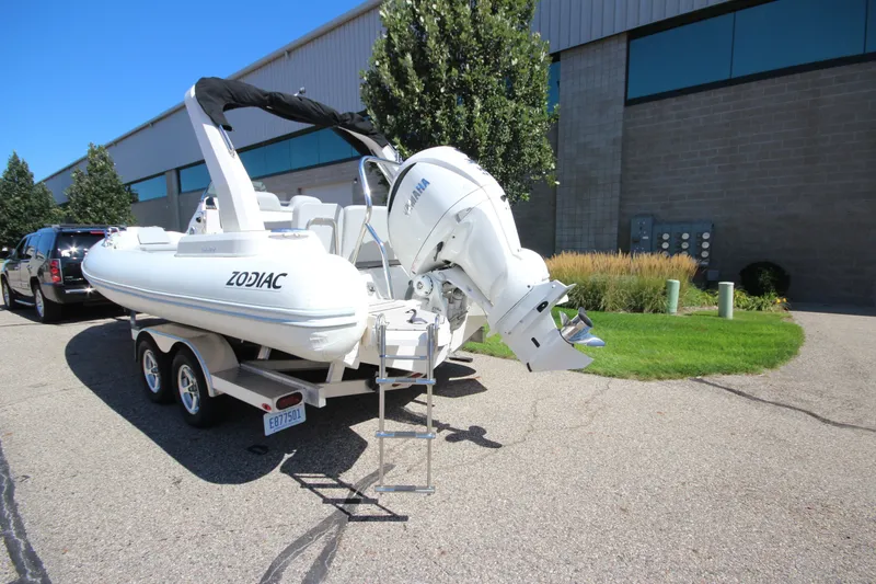 Slide: The Image of 2023 Zodiac Medline 7.5 boat on trailer, parked outdoors near a building. - 6