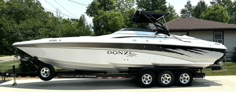 Slide: The Image of A 2005 Donzi 33 ZX on a trailer, parked in a residential area. - 2