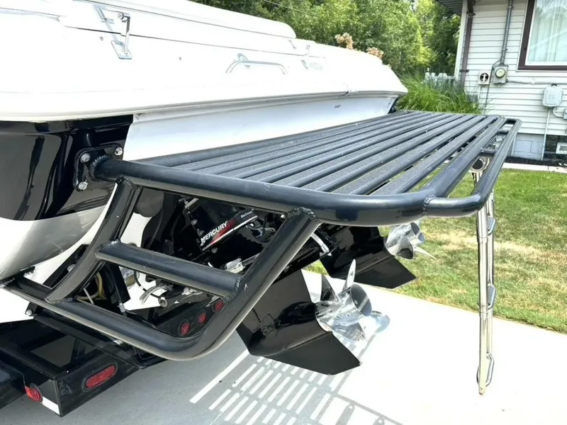 Slide: The Image of The image shows the stern of a 2005 Donzi 33 ZX with a swim platform and ladder. - 13