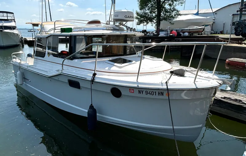 The Image of A white 2021 Ranger Tugs R-23 boat docked at a pier. - 1