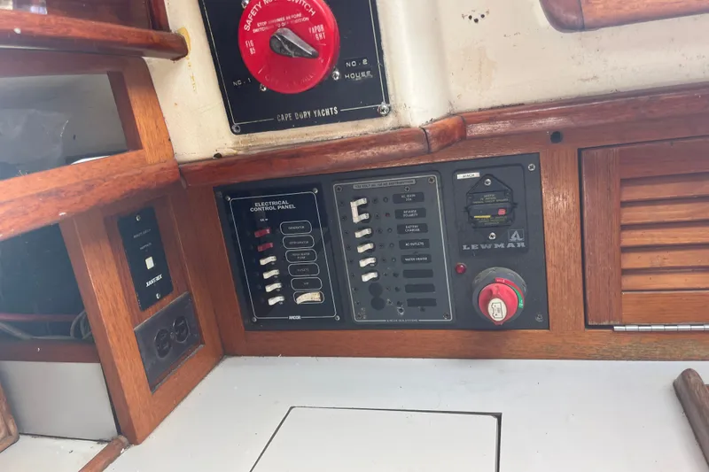 Slide: The Image of Electrical control panel on a 1980 Cape Dory 30 sailboat, featuring switches and safety controls. - 29
