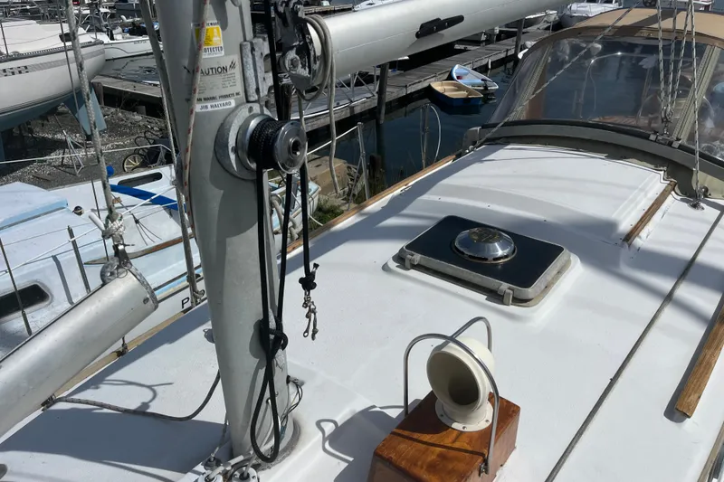 Slide: The Image of 1980 Cape Dory 30 sailboat deck with winch and hatch, docked at marina. - 15