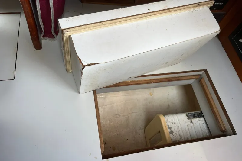 Slide: The Image of Open hatch on 1980 Cape Dory 30 sailboat, revealing storage compartment. - 23