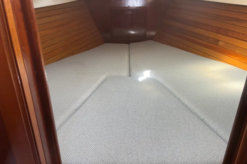 Slide: The Image of Cozy cabin interior of 1980 Cape Dory 30 sailboat with wooden paneling and cushioned berth. - 25