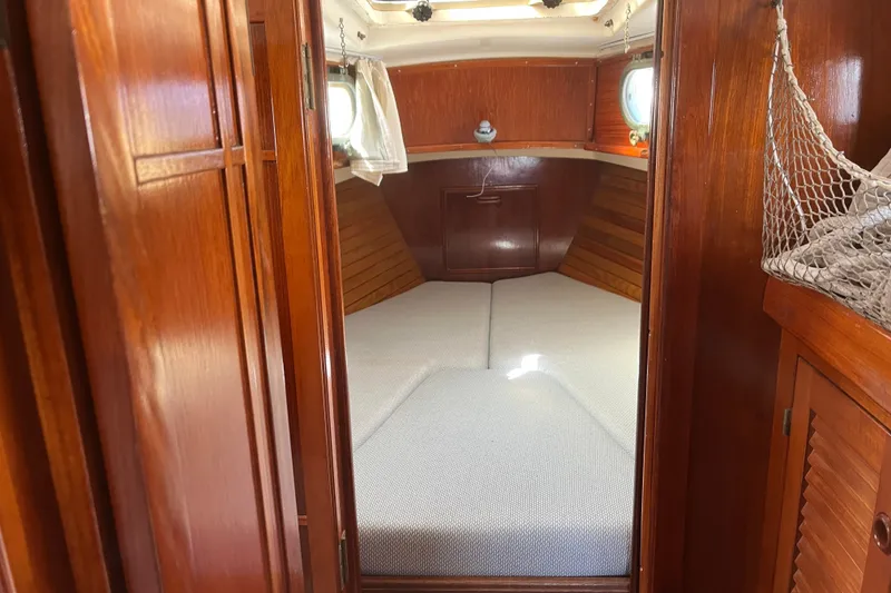 Slide: The Image of Cozy cabin interior of 1980 Cape Dory 30 sailboat with wooden finish and cushioned berth. - 24