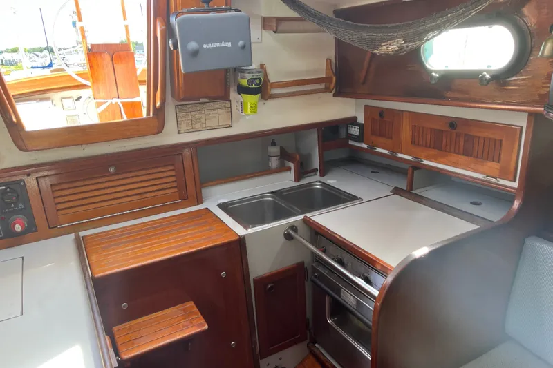 Slide: The Image of Interior of a 1980 Cape Dory 30 sailboat featuring a compact kitchen area. - 20
