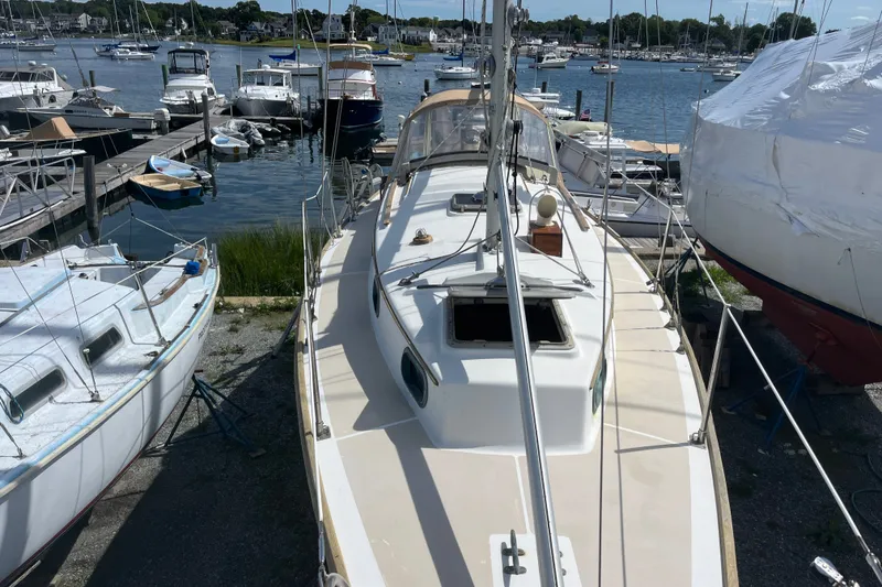 Slide: The Image of 1980 Cape Dory 30 sailboat docked at a marina, surrounded by other boats. - 14