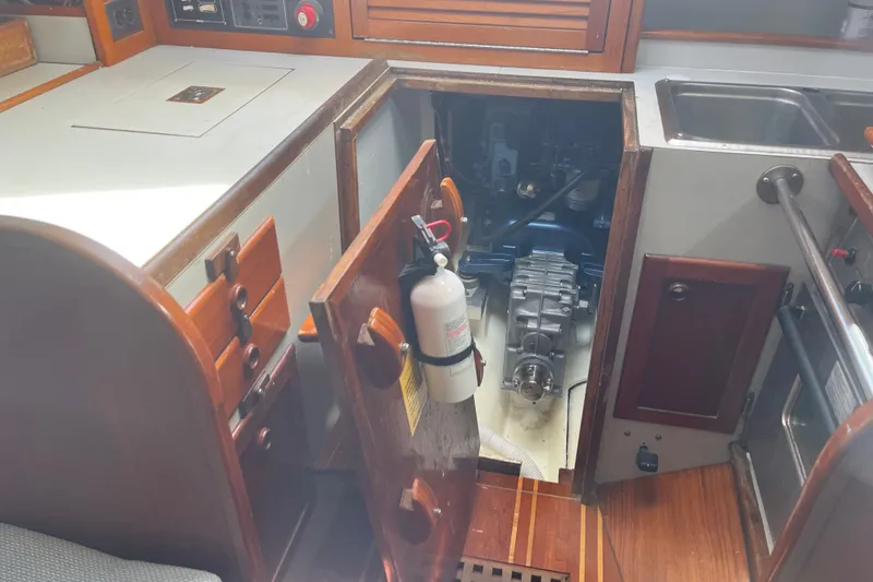 Slide: The Image of Engine compartment of a 1980 Cape Dory 30 sailboat with wooden interior. - 30