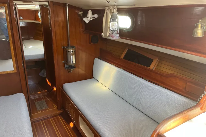 Slide: The Image of Interior of 1980 Cape Dory 30 sailboat with wooden finish and cozy seating. - 18