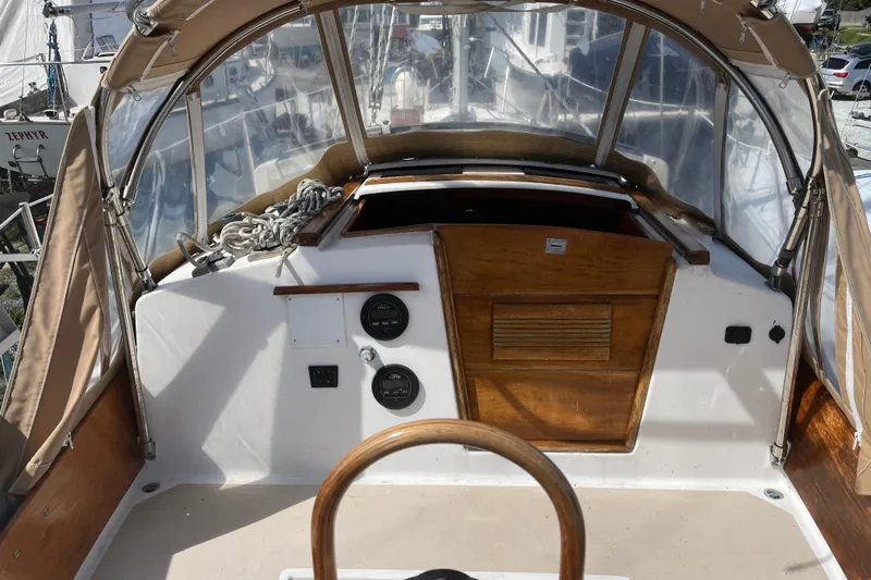 Slide: The Image of Cockpit of 1980 Cape Dory 30 sailboat with wooden accents and protective canopy. - 9