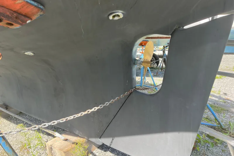 Slide: The Image of 1980 Cape Dory 30 sailboat hull with visible propeller and rudder on stands. - 4
