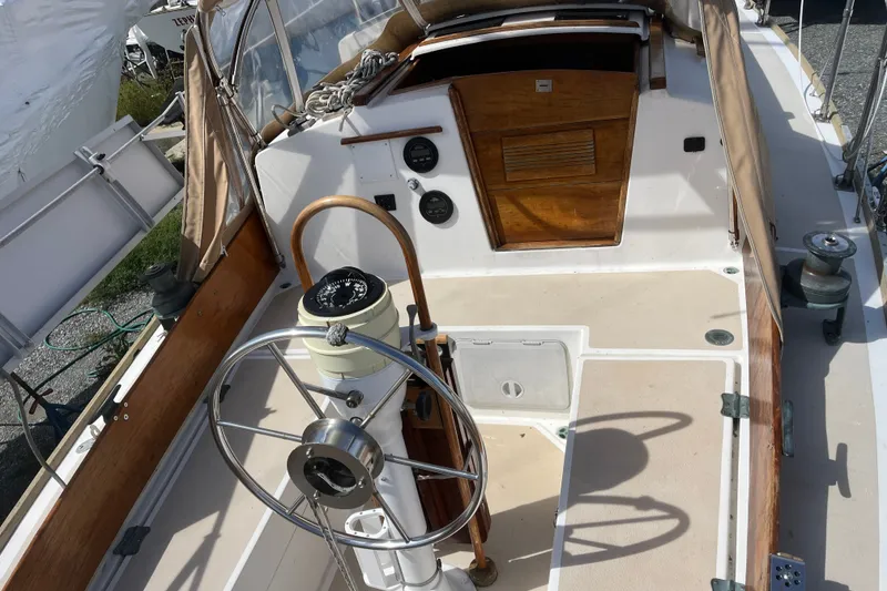 Slide: The Image of Cockpit of a 1980 Cape Dory 30 sailboat with wooden accents and steering wheel. - 6