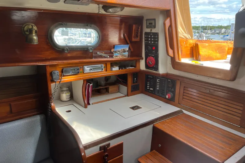 Slide: The Image of Interior of a 1980 Cape Dory 30 sailboat with wooden cabinetry and navigation equipment. - 19