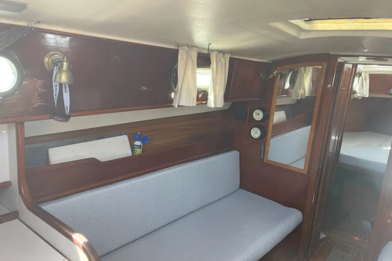Slide: The Image of Interior of a 1980 Cape Dory 30 sailboat with wooden finishes and seating area. - 17