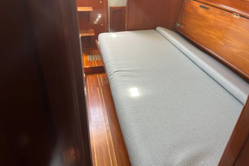 Slide: The Image of Interior cabin of 1980 Cape Dory 30 sailboat with wooden finish and cushioned berth. - 27