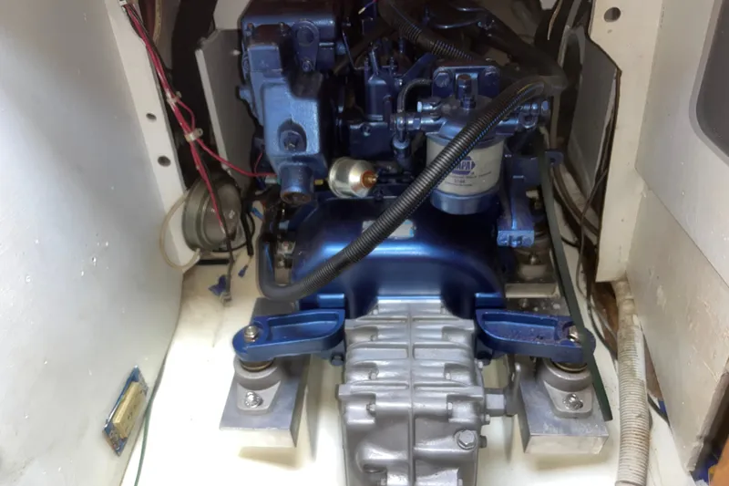 Slide: The Image of Engine compartment of a 1980 Cape Dory 30 sailboat, showcasing mechanical components. - 33