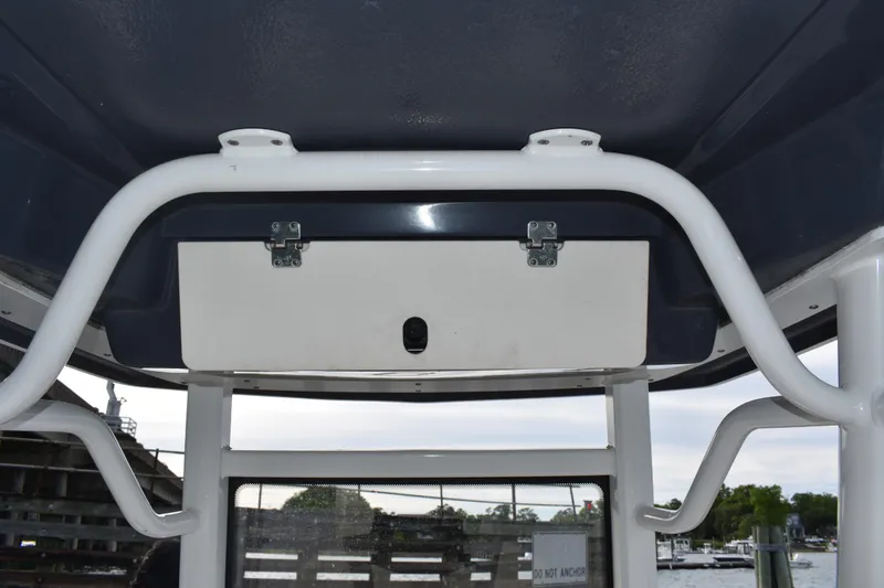 Slide: The Image of 2022 Robalo 246 Cayman boat T-top with storage compartment and sturdy frame. - 17