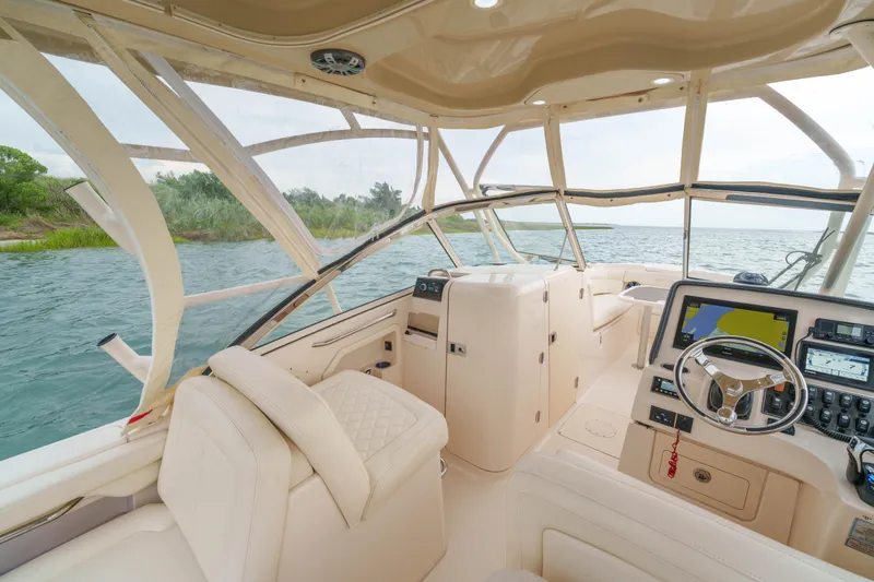 Slide: The Image of Interior view of 2021 Grady-White Freedom 275 boat with modern dashboard and seating. - 6