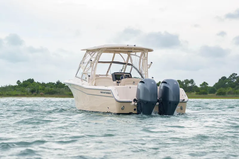 Slide: The Image of 2021 Grady-White Freedom 275 boat on water, featuring dual outboard engines. - 3