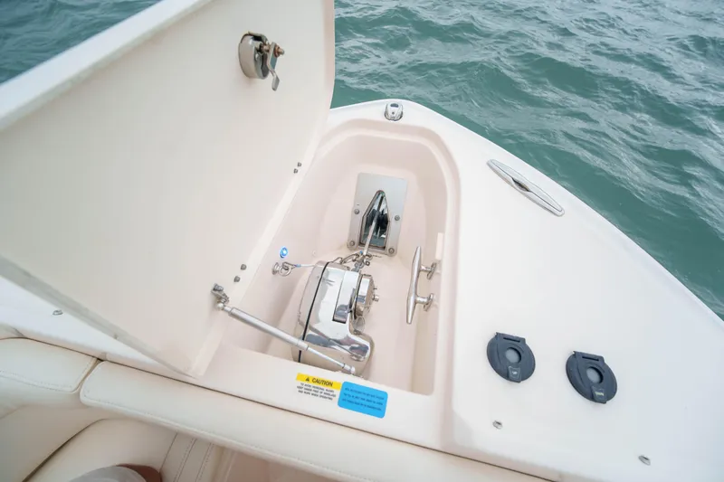 Slide: The Image of Anchor compartment of 2021 Grady-White Freedom 275 boat on water. - 12