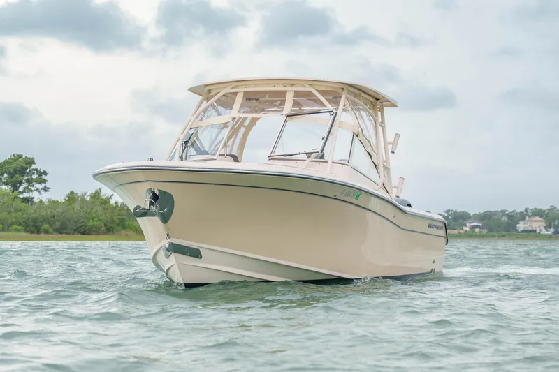 Slide: The Image of 2021 Grady-White Freedom 275 boat on water, showcasing sleek design and sturdy build. - 1