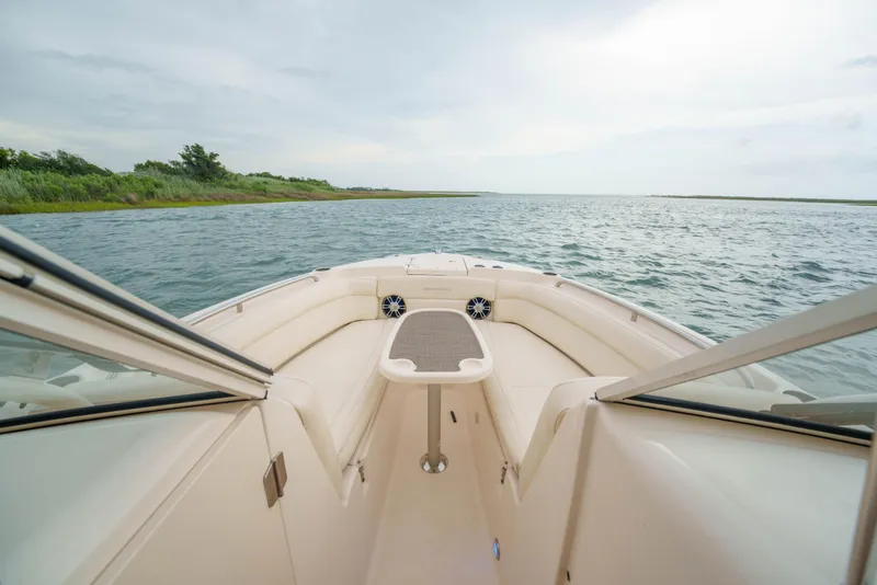 Slide: The Image of 2021 Grady-White Freedom 275 boat cruising on calm waters, scenic view ahead. - 10