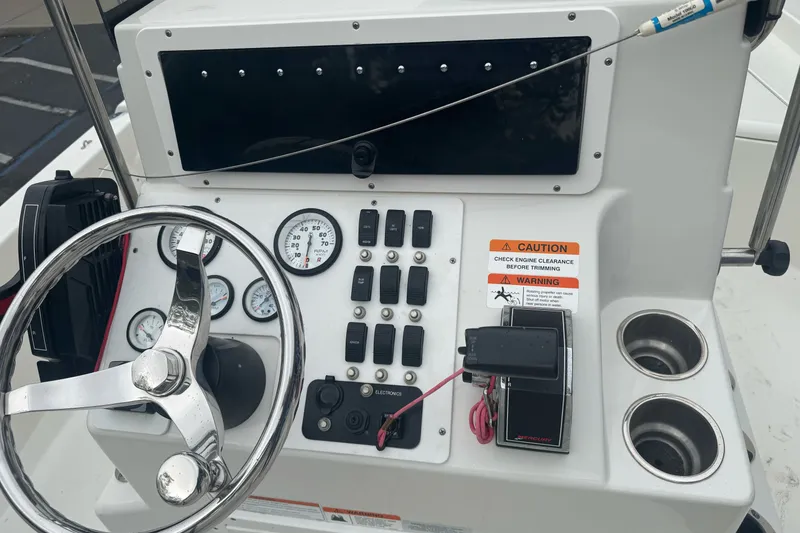 Slide: The Image of Control panel of a 2012 Ranger 220 Bahia boat with steering wheel and gauges. - 21