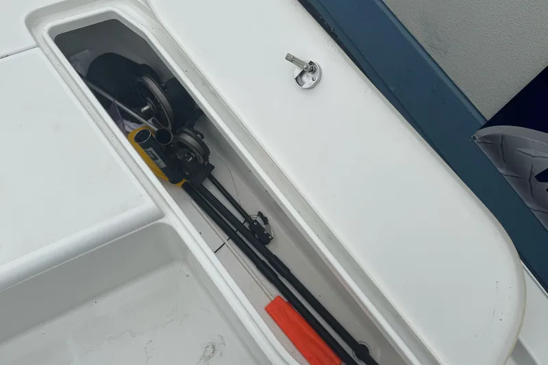 Slide: The Image of Storage compartment on a 2012 Ranger 220 Bahia boat with fishing gear inside. - 12