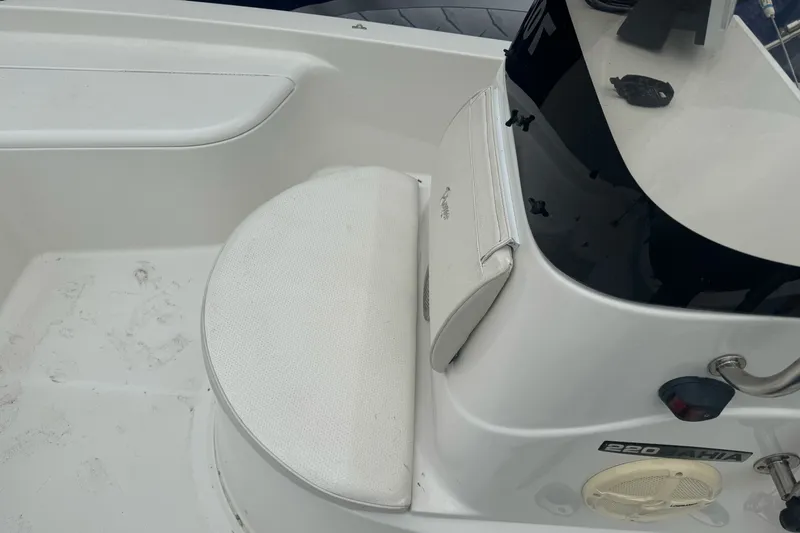 Slide: The Image of Interior of a 2012 Ranger 220 Bahia boat, featuring seating and console details. - 18