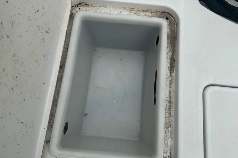 Slide: The Image of Storage compartment of a 2012 Ranger 220 Bahia boat, showing interior details. - 6