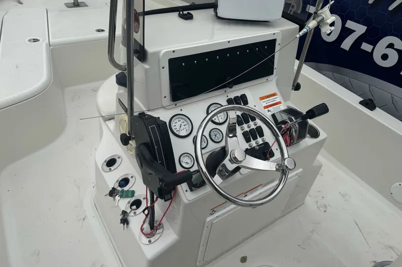 Slide: The Image of 2012 Ranger 220 Bahia boat console with steering wheel and control panel. - 16