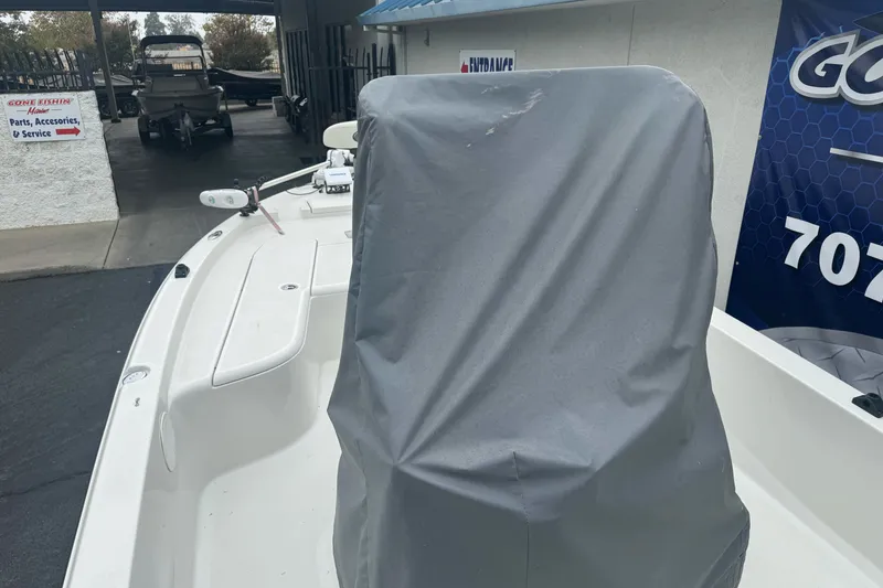 Slide: The Image of 2012 Ranger 220 Bahia boat with covered console, parked at a service center. - 9