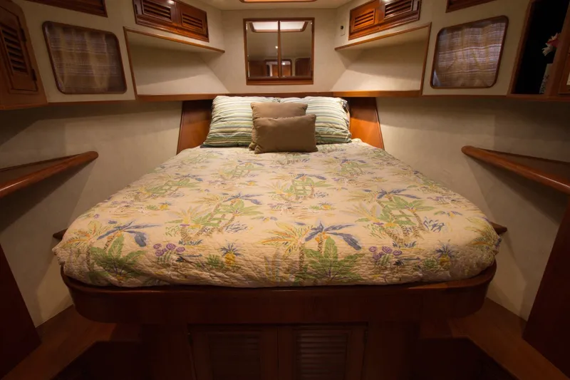 Slide: The Image of Cozy bedroom in 1997 Offshore Yachts Pilothouse Motoryacht with floral bedding and wooden accents. - 21