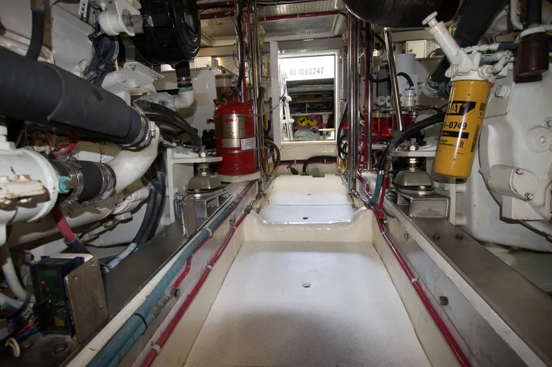 Slide: The Image of Engine room of a 1997 Offshore Yachts Pilothouse Motoryacht, showcasing mechanical components. - 24