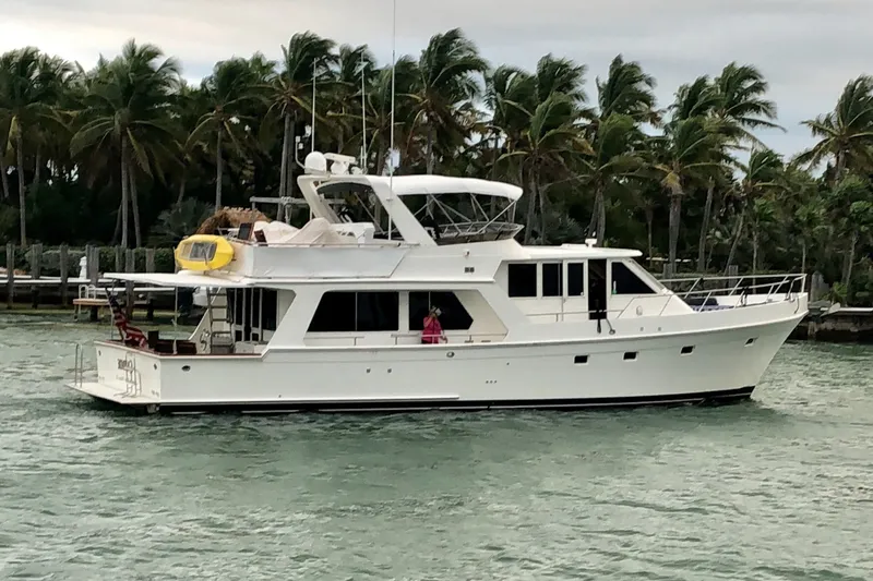 The Image of 1997 Offshore Yachts Pilothouse Motoryacht cruising near palm trees. - 1
