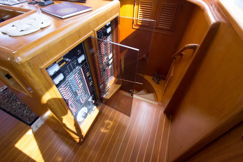 Slide: The Image of 1997 Offshore Yachts Pilothouse Motoryacht interior with wooden stairs and control panel. - 19