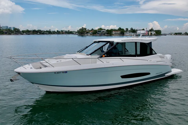 The Image of 2022 Regal 36 XO boat on calm water, showcasing sleek design and modern features. - 0