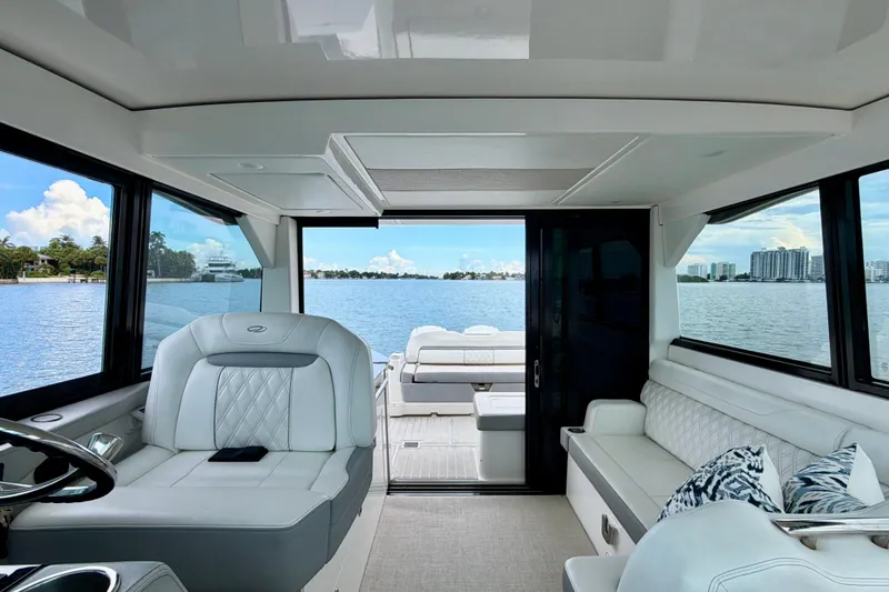 Slide: The Image of Interior of 2022 Regal 36 XO yacht with luxurious seating and scenic water view. - 22