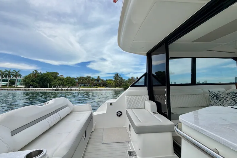 Slide: The Image of Luxurious 2022 Regal 36 XO yacht interior with waterfront view and plush seating. - 16