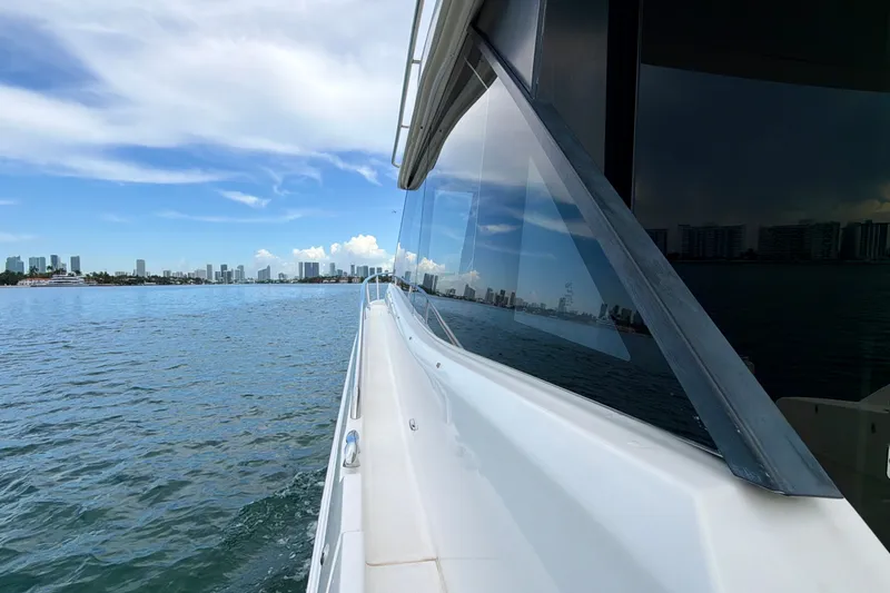 Slide: The Image of 2022 Regal 36 XO yacht cruising near city skyline under blue sky. - 26