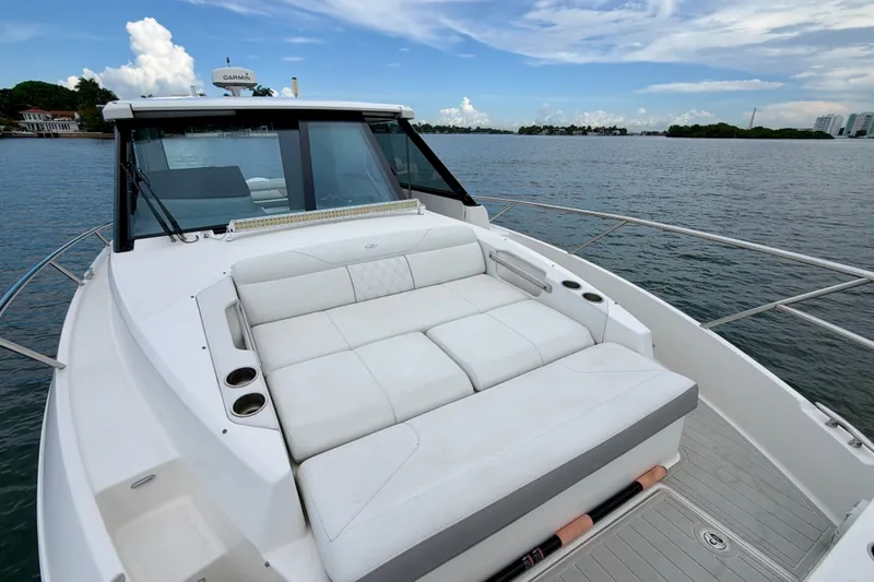 Slide: The Image of 2022 Regal 36 XO yacht with spacious deck seating on calm waters. - 31