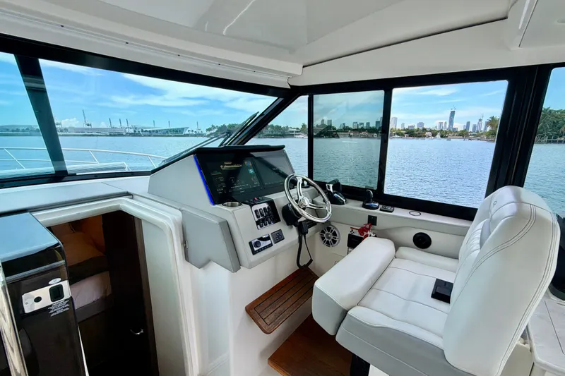 Slide: The Image of Interior view of 2022 Regal 36 XO yacht cockpit with city skyline in background. - 20