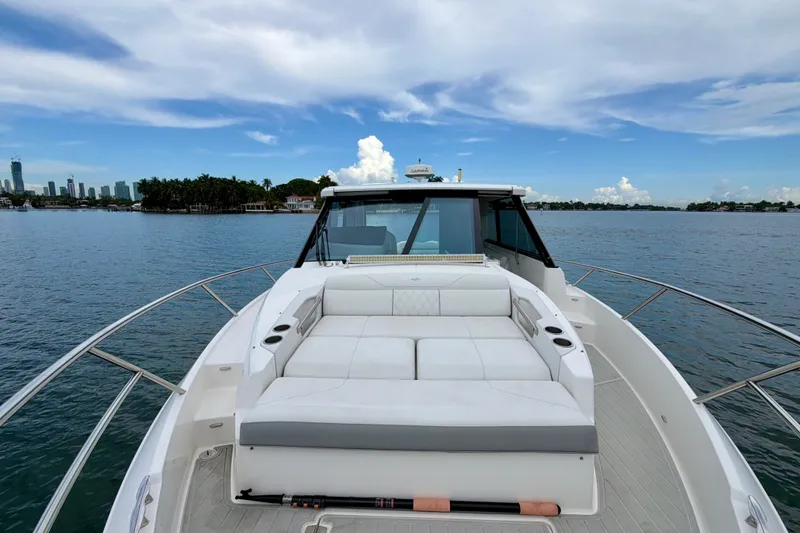 Slide: The Image of 2022 Regal 36 XO yacht with spacious deck, cruising on calm waters under a blue sky. - 30