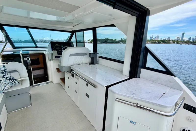Slide: The Image of Interior of 2022 Regal 36 XO yacht with modern helm and waterfront view. - 17