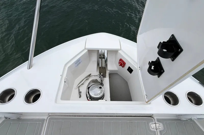 Slide: The Image of 2022 Regal 36 XO boat anchor compartment with open hatch, showing anchor and controls. - 33