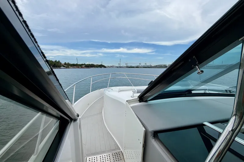 Slide: The Image of 2022 Regal 36 XO yacht deck view with open water and sky. - 28