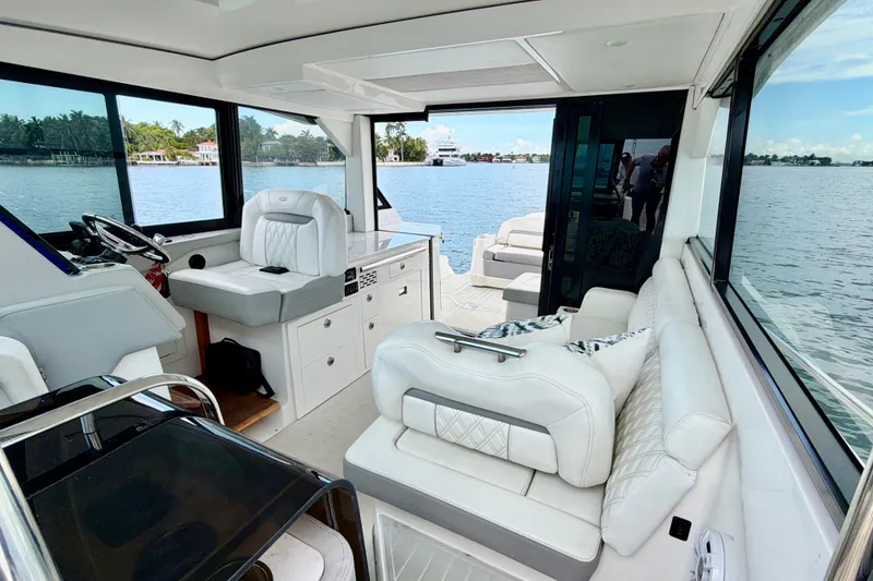 Slide: The Image of Luxurious interior of 2022 Regal 36 XO yacht with plush seating and scenic water views. - 23