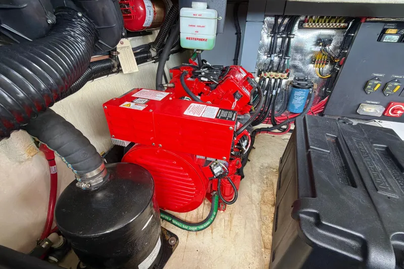 Slide: The Image of Engine room of 2022 Regal 36 XO boat with red generator and wiring. - 46